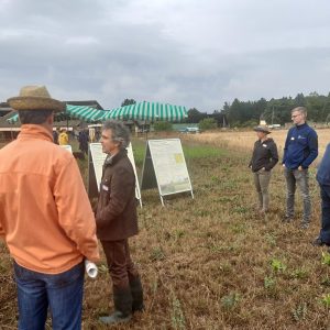 Personengruppe bei einem Vortrag auf einem Feld